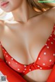 A woman in a red and white polka dot bikini.