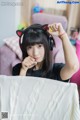 A woman sitting on a couch wearing a pair of headphones.