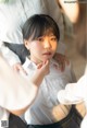 A young girl in a school uniform is getting ready for her wedding.